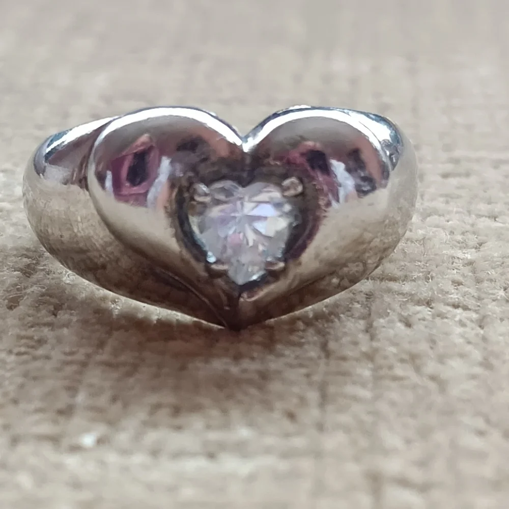 Silver Ring with a Heart Design Featuring a Sparkling Rhinestone Centerpiece.